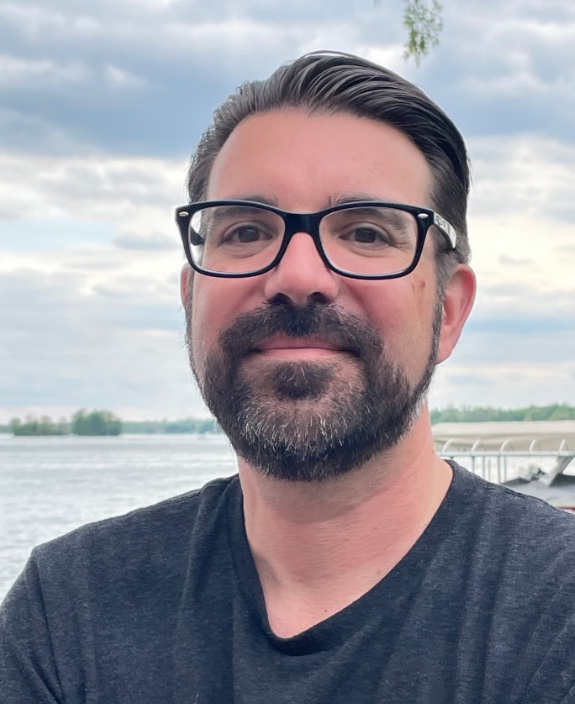 AWS 首席解决方案架构师 Chris Chalfant 穿着休闲服在户外的照片。