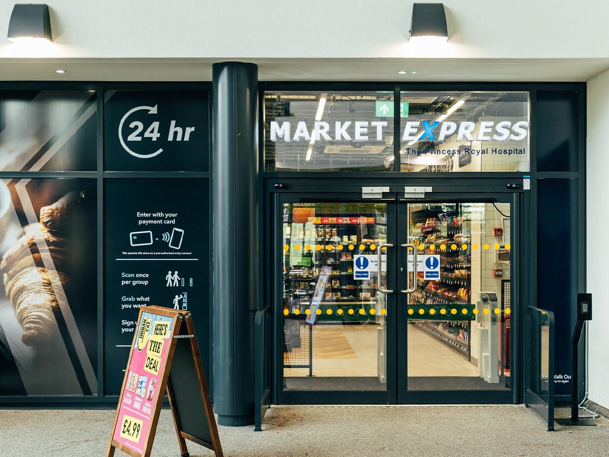 Entrance to Market Express, a 24-hour grab-and-go market located at The Princess Royal Hospital, featuring self-service and contactless payment options.