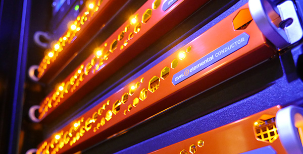 Close-up view of an AWS Elemental Conductor server rack with glowing status lights in a data center or technical environment.