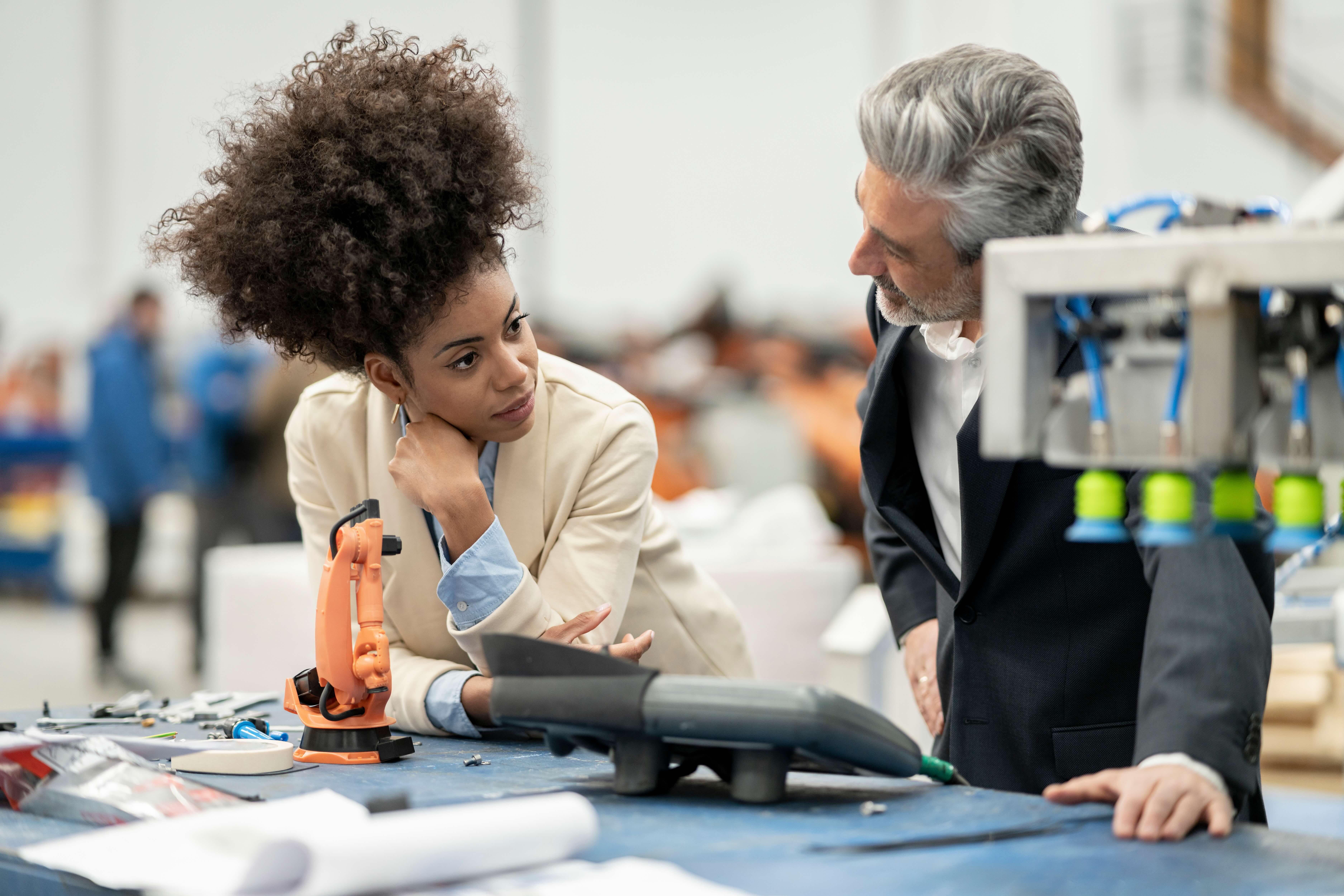 Engineers talking with each other standing in factory
