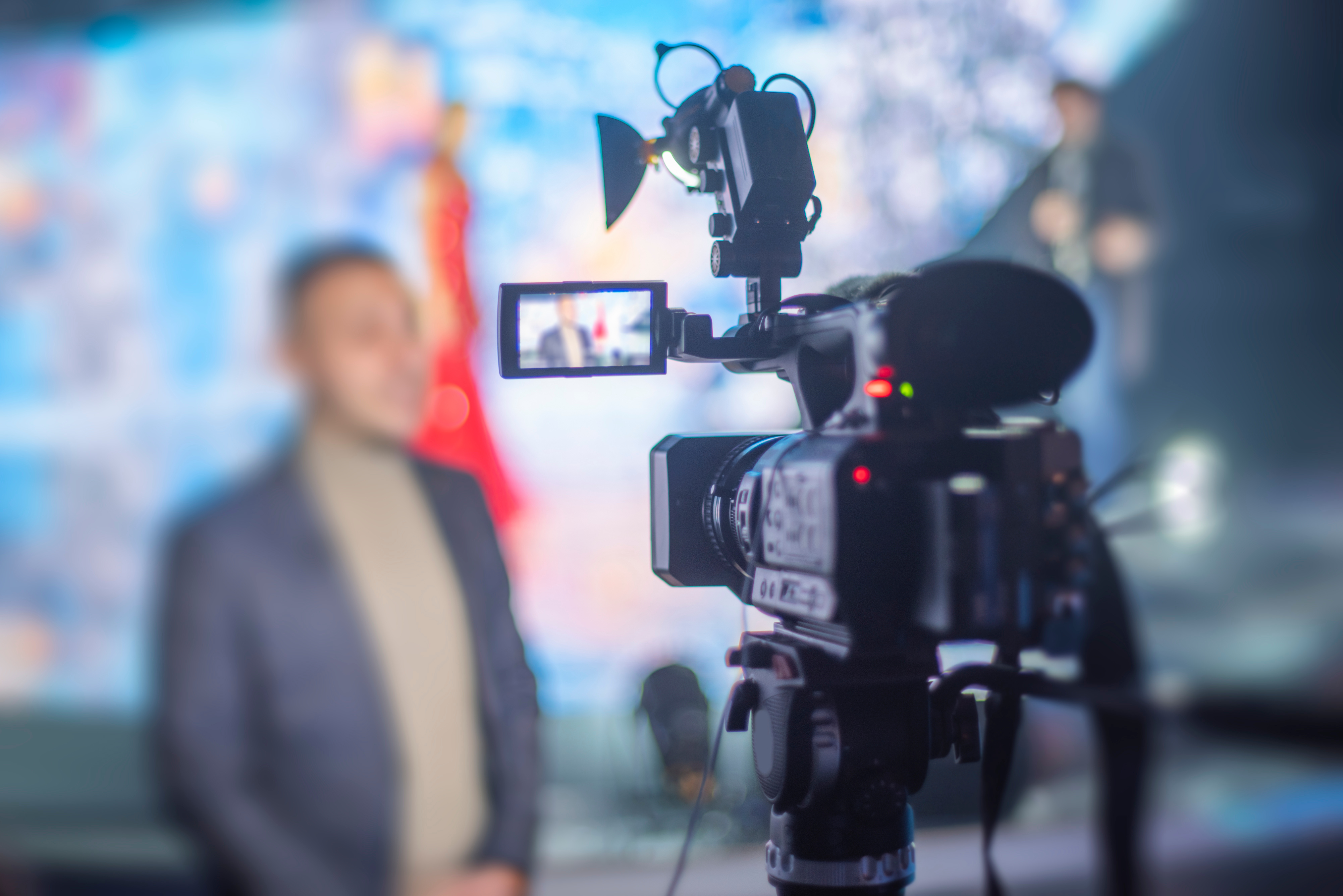 cameraman filming an interview on a tv camera