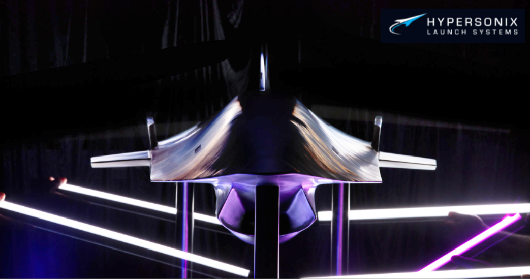 Front view of a Hypersonix Launch Systems aerospace vehicle, displayed in a dramatic lighting environment with the Hypersonix Launch Systems logo in the top right corner.