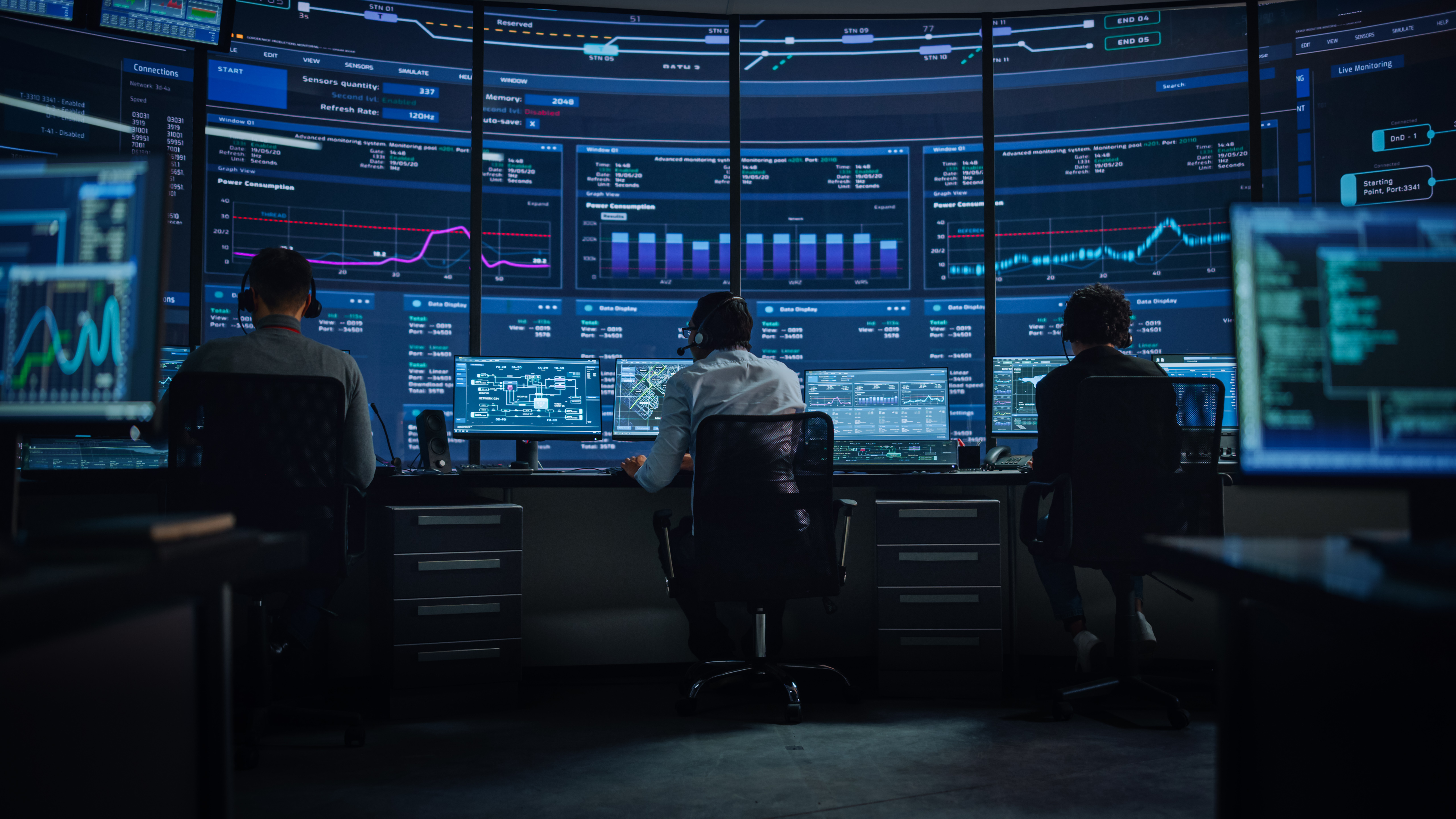 Professional IT Technical Support Specialists and Software Programmer Working on Computers in Monitoring Control Room with Digital Screens with Server Data, Blockchain Network and Surveillance Maps.