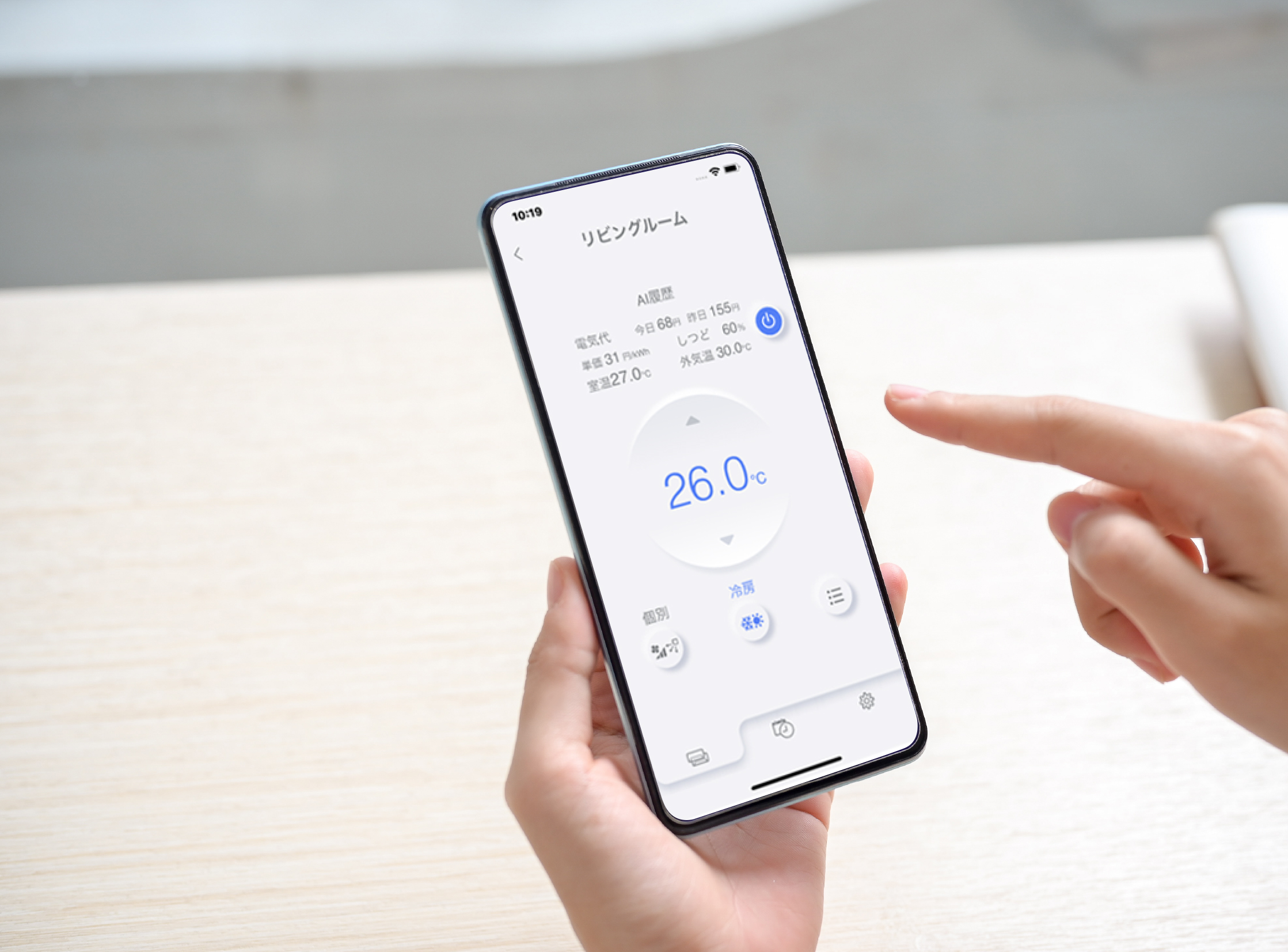 A close-up image of a woman sitting at a table indoors and using her smartphone. a smartphone white-screen mockup for display your graphic ads