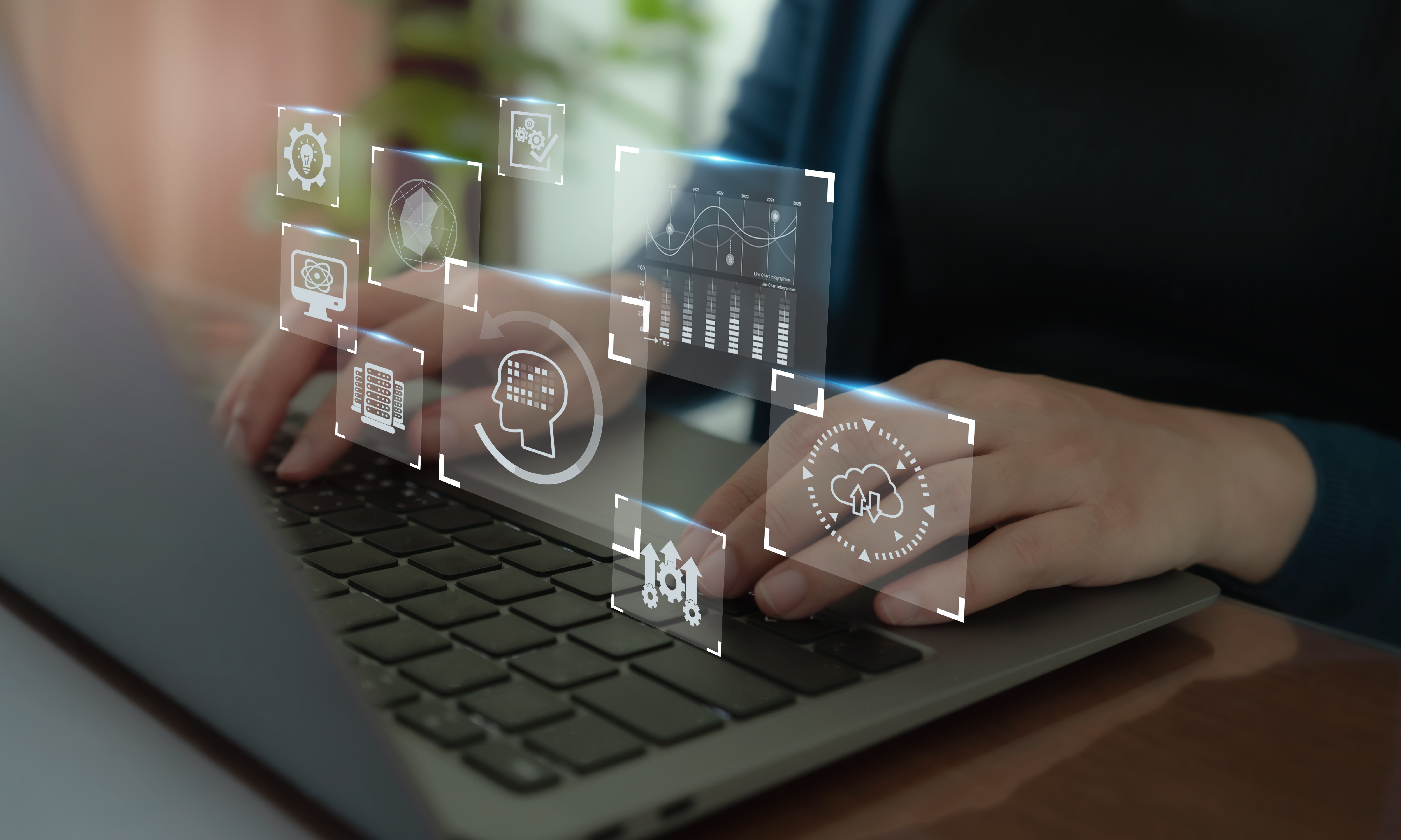 Hands typing on a laptop keyboard with digital overlay icons representing artificial intelligence, data analytics, automation, and cloud computing concepts. This image suggests technology integration and modern business solutions.