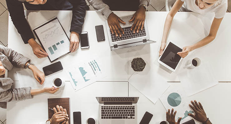 top view work workplace. A team of young office workers, businessmen with laptop working at the table, communicating together in an office. Corporate businessteam and manager in a meeting. coworking