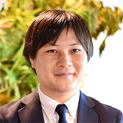Business portrait of a man in a suit with a plant background
