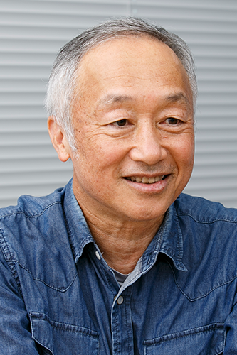 Portrait of an older man wearing a denim shirt, smiling and looking slightly to the side. The image is used in relation to the Asahi Kasei case study.
