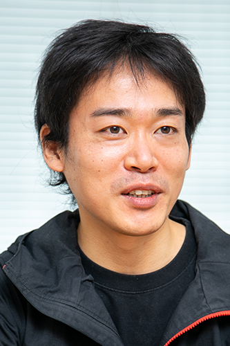 Portrait photo of a person in a black jacket, featured in the Drecom solution case study.