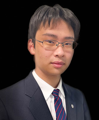 A portrait of a male speaker in a suit and tie used in the Nishiyamato case study.