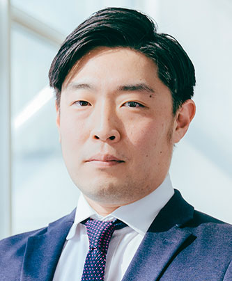 Portrait of a male speaker in a suit and tie, featured in the HG University case study.