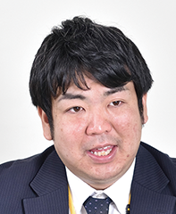 Portrait of a business professional in a suit and tie on a plain background.