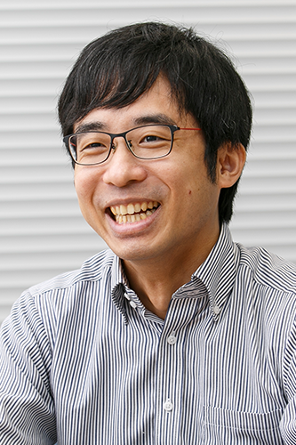 A smiling man with black hair, wearing glasses and a striped shirt, posing in front of a neutral background. This image is used for the Asahi Kasei solution case study.