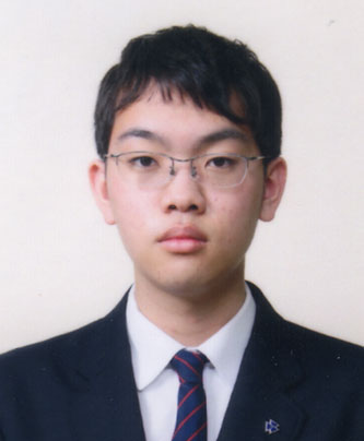 A formal portrait of a student in a suit and tie, used for a case study at Nishiyamato School.